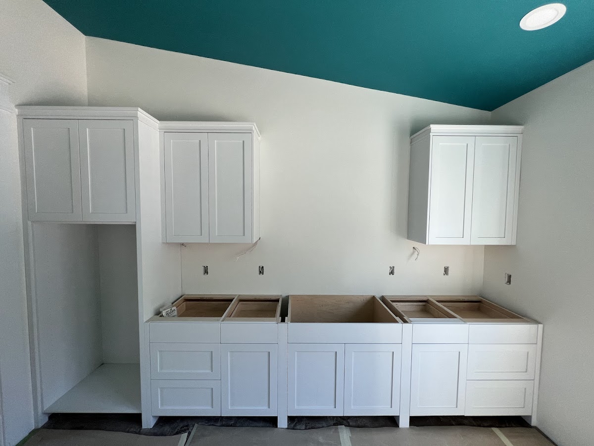 White wall cabinetry and base cabinets from a customer review photo