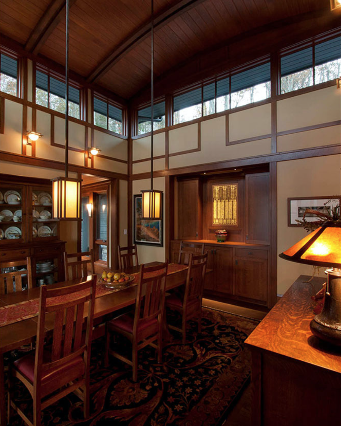 Warm wood built-in cabinetry in a high-ceiling room
