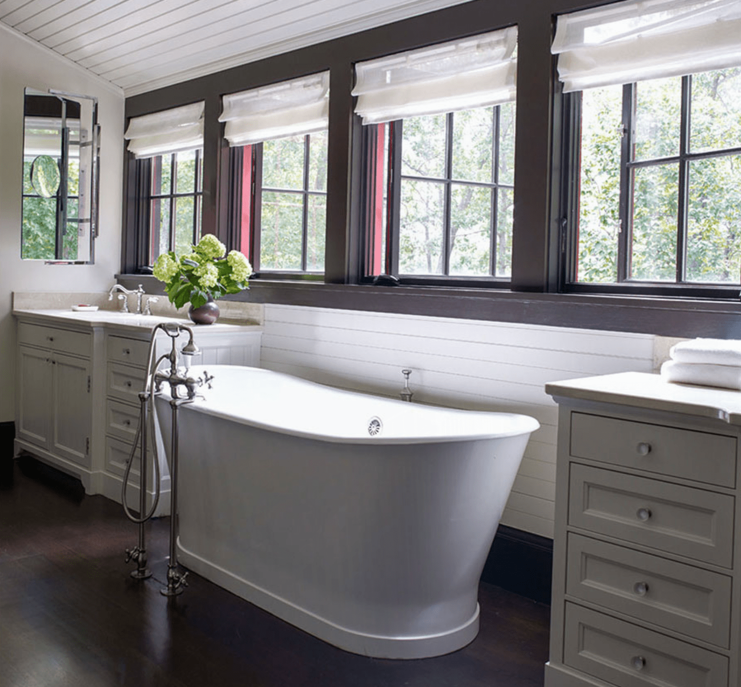Bathroom cabinetry beside a freestanding tub