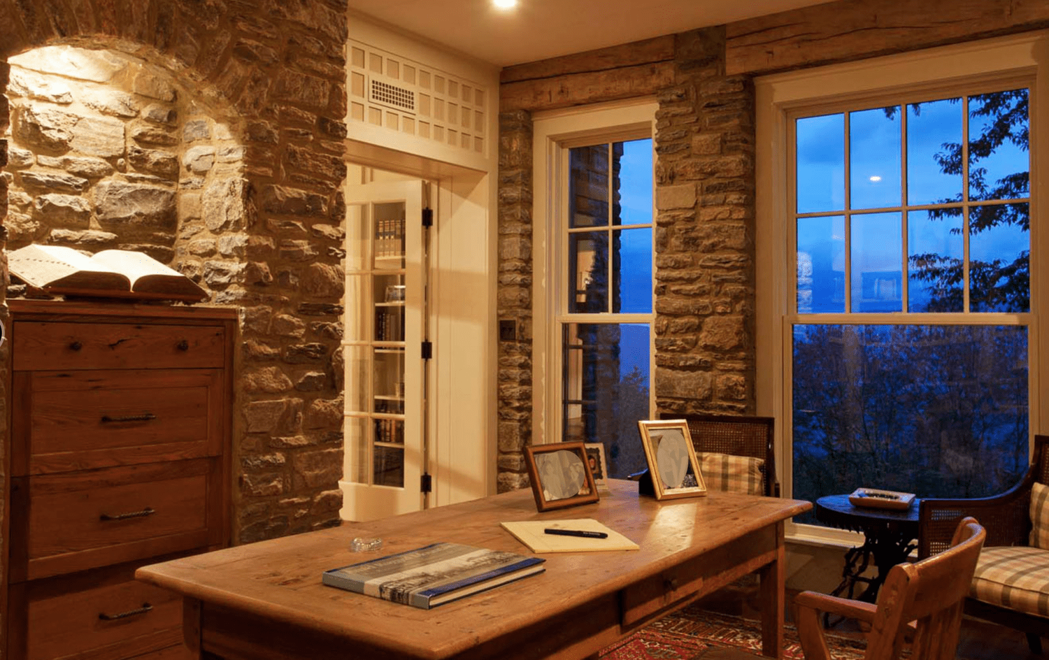 Wood desk and shelving built into stone niche