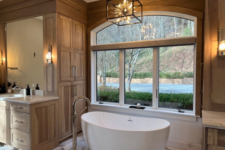 Bathroom cabinetry and tub surround with large window