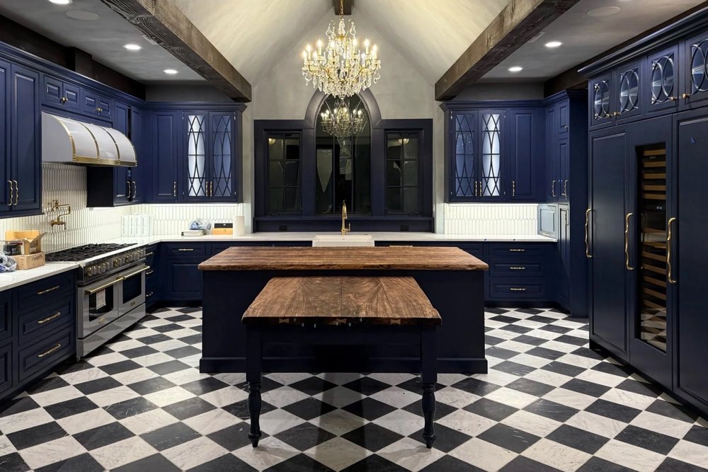 Finished kitchen cabinetry with dark cabinets and island